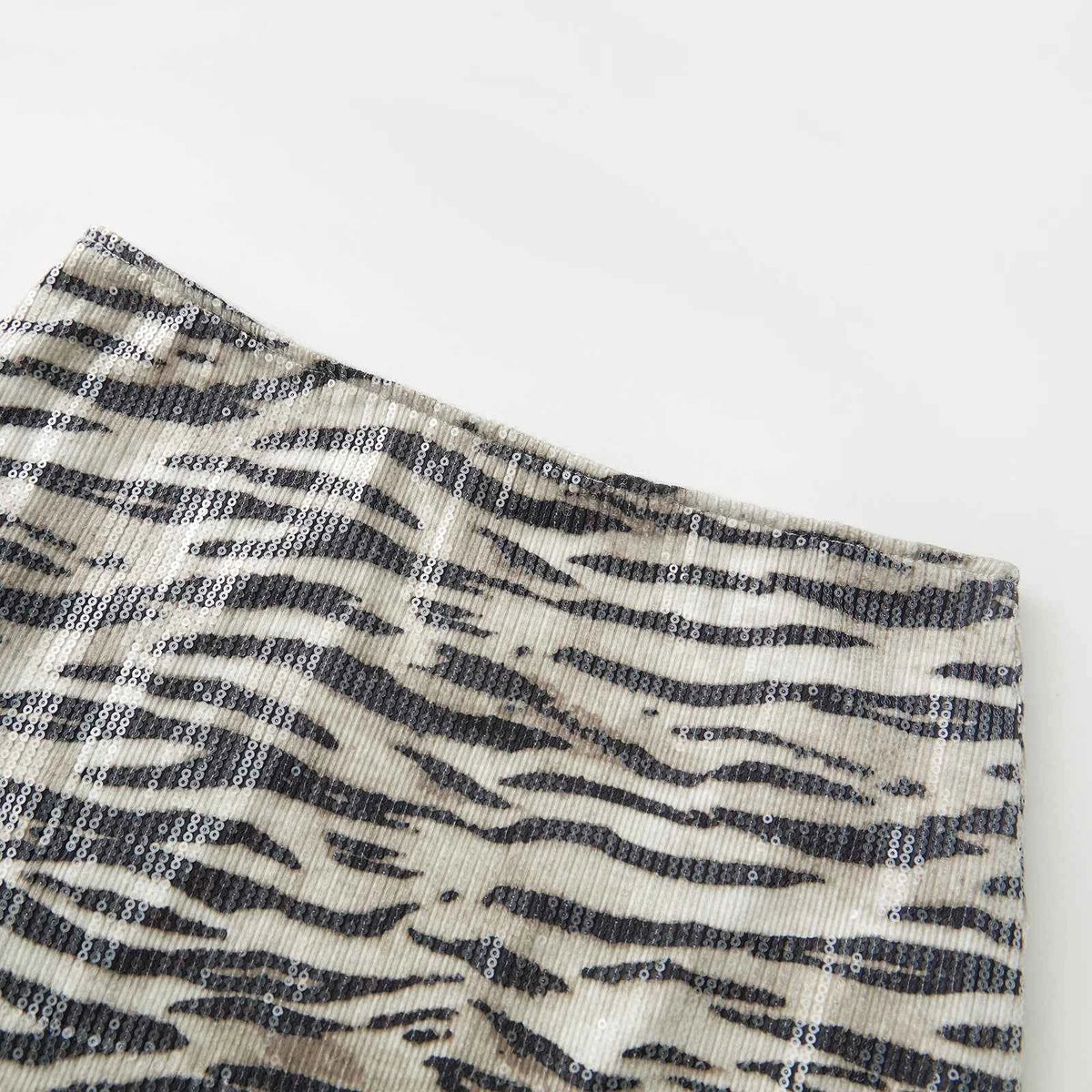 Mini skirt with zebra print and shiny sequins from Corporación Turística, featuring a stylish and vibrant animal print design.