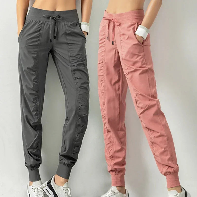 Navy blue women's athletic sweatpants with drawstring, made of soft fabric, designed for running and comfortable casual wear.