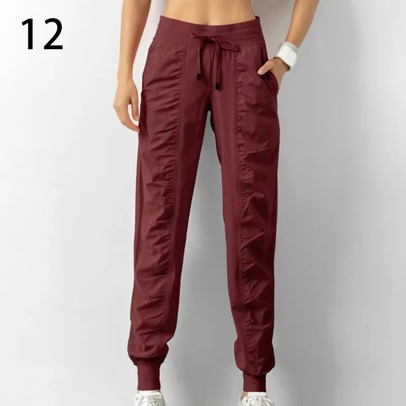 Navy blue women's sweatpants with drawstring, made of soft fabric, featuring a relaxed fit for running and casual wear.