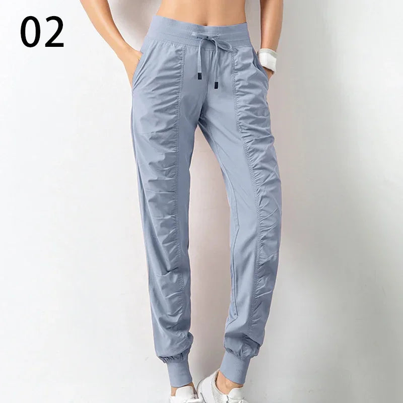Navy blue women's athletic sweatpants with drawstring waist from Corporación Turística, made of soft fabric for running and casual wear.