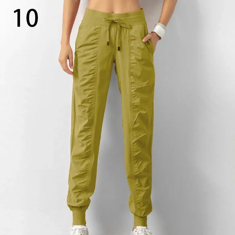 Navy blue women's athletic sweatpants with drawstring from Corporación Turística, made of soft fabric for running and casual wear.