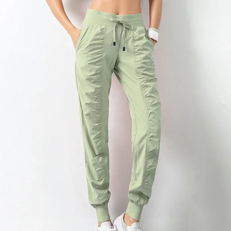 Navy blue women's sweatpants with drawstring, made of soft fabric, designed for running or casual wear.