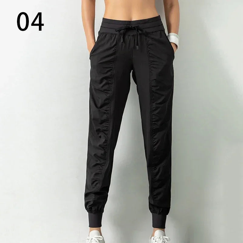Navy blue women's sweatpants with drawstring, made of soft fabric, featuring a relaxed fit and comfortable elastic waistband.