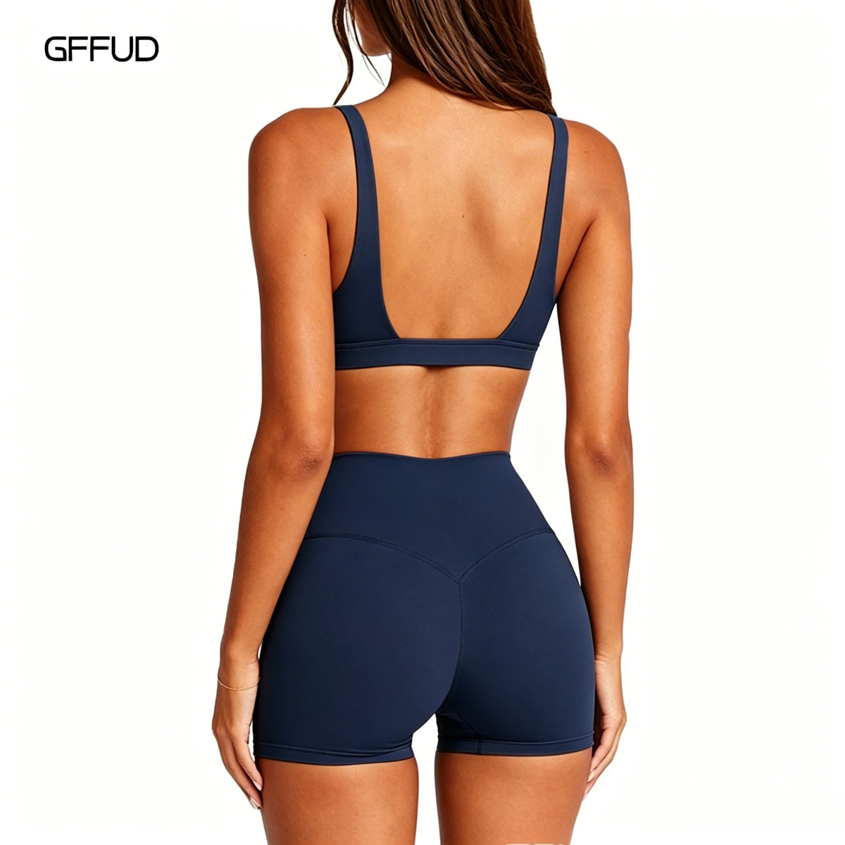 Navy women's yoga set with sports bra and matching leggings from Corporación Turística, displayed on a model.