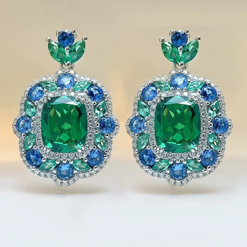 Vintage jewelry set featuring rectangular emerald pendant necklace and matching earrings by Corporación Turística.