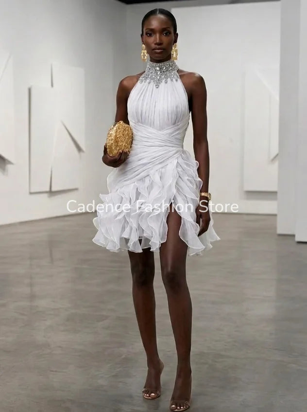 Short white halter neck evening dress with beaded embellishments, featuring a fitted silhouette and elegant design.