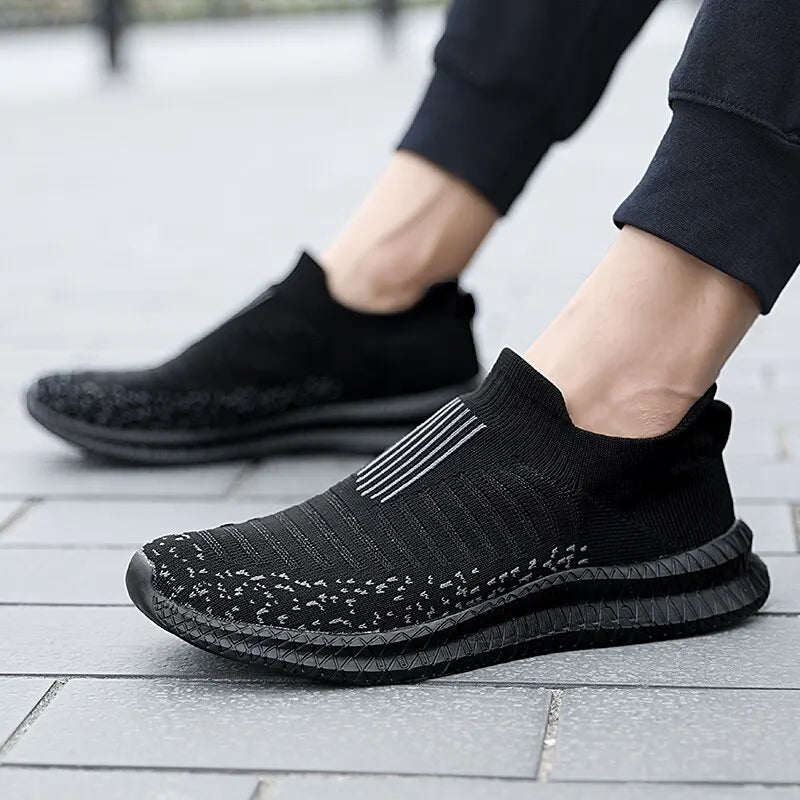 Black men's breathable sneakers by Corporación Turística, comfortable athletic shoes with mesh design for everyday wear.