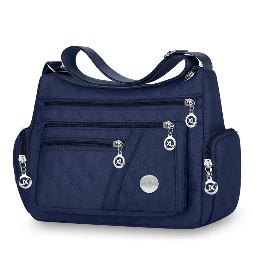 Black nylon padded crossbody bag by Corporación Turística, stylish and lightweight for women.
