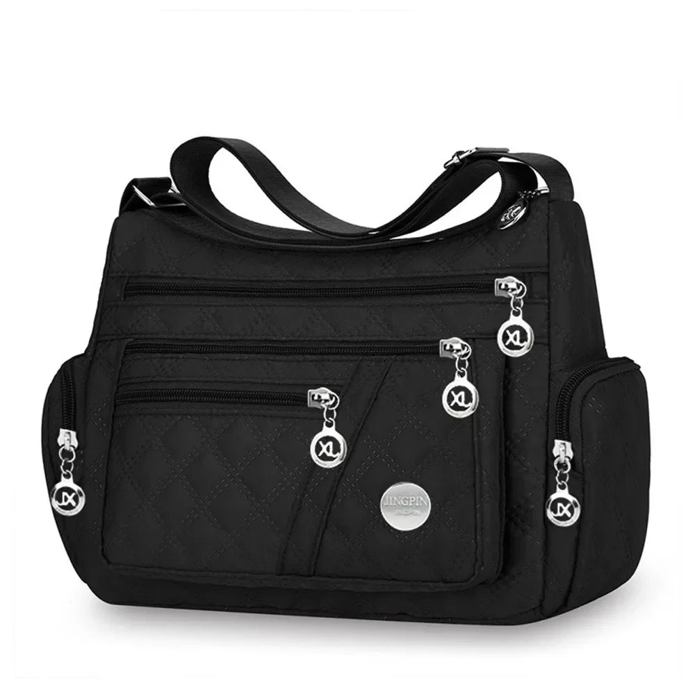 Black nylon quilted shoulder bag for women from Corporación Turística, featuring a stylish pomelo design.