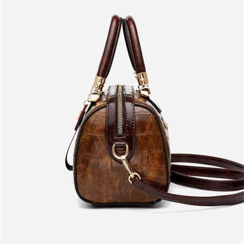 Luxury designer women's shoulder bag in black with sleek, sophisticated style, featuring elegant stitching and a structured shape.