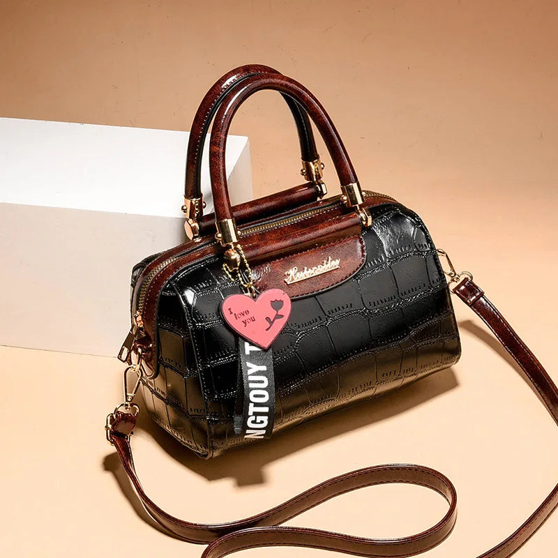 Luxury designer women's shoulder bag by Corporación Turística in black, featuring elegant detailed craftsmanship.
