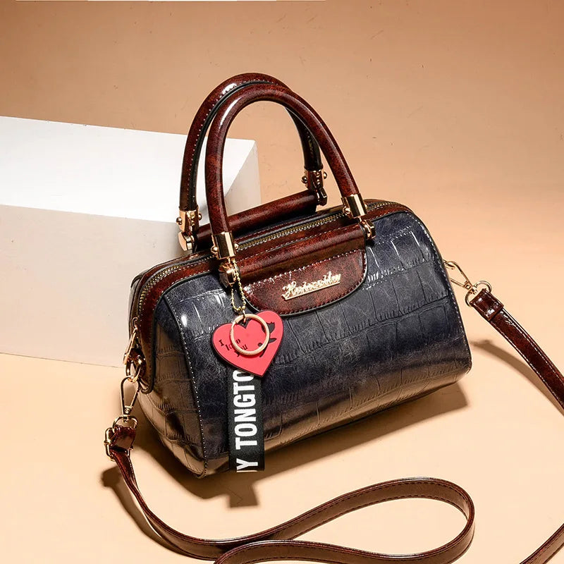 Luxury designer women's black shoulder bag by Corporación Turística, featuring sleek style and elegant craftsmanship.