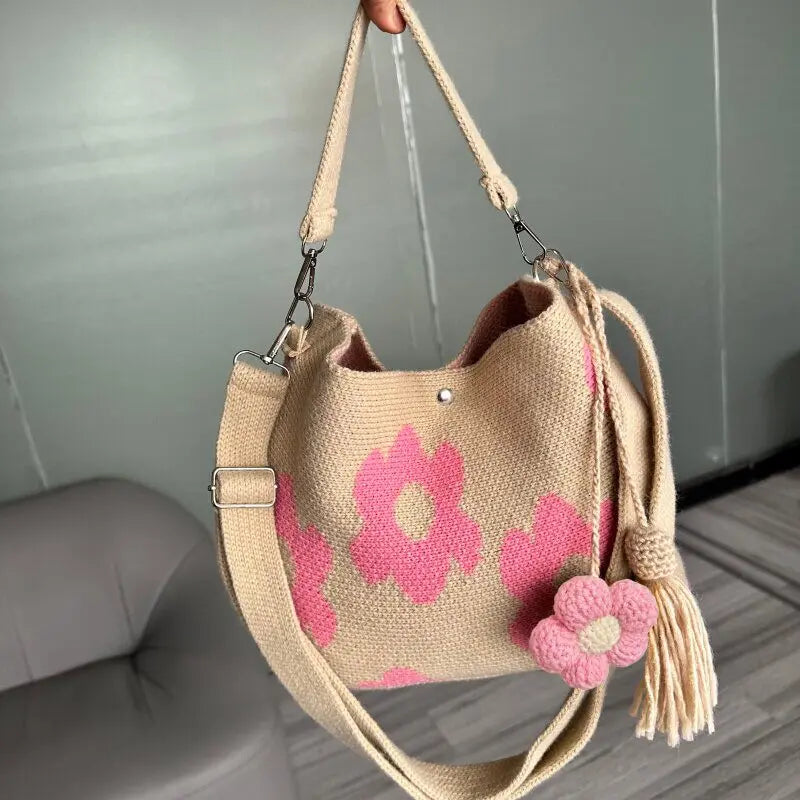Handmade black crochet handbag with colorful floral details, crafted by Corporación Turística.