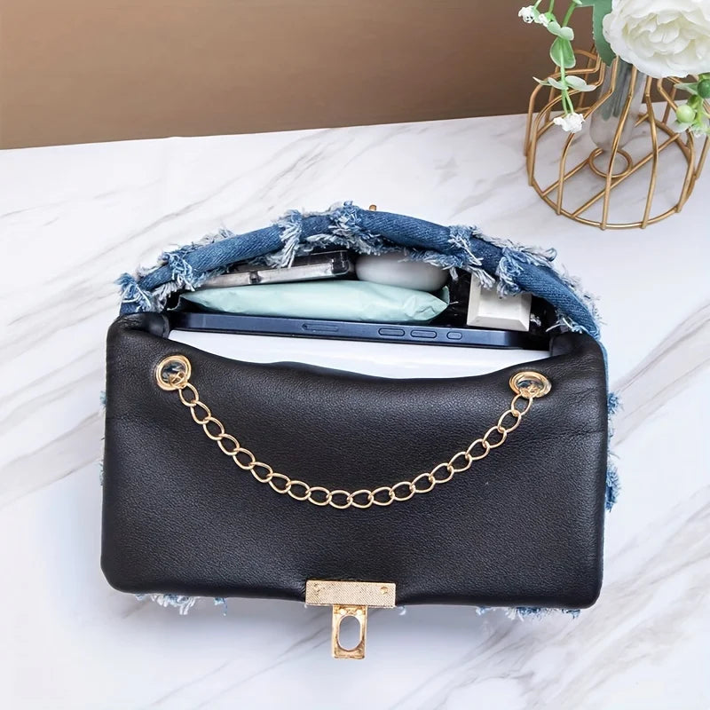 Black crossbody handbag by Corporación Turística, stylish for jeans, featuring a compact and versatile design.