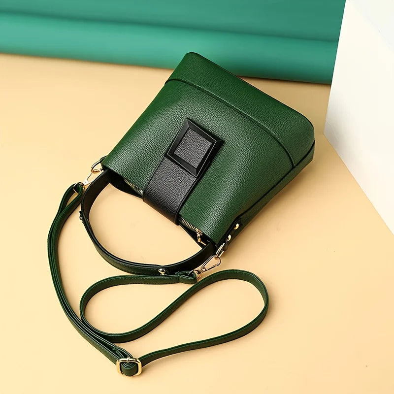 Elegant black solid color bucket bag by Corporación Turística with adjustable shoulder strap and spacious interior.