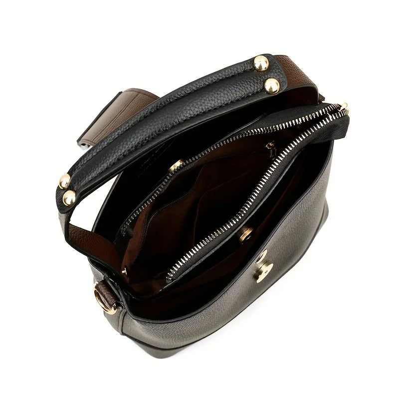 Elegant black solid color bucket bag with adjustable shoulder strap by Corporación Turística, featuring a sleek and minimalist design.