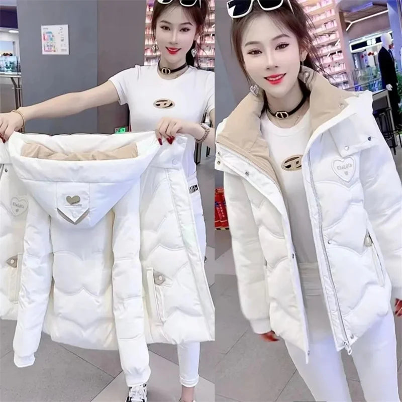 Black women's winter parka jacket by Corporación Turística, featuring a warm, stylish winter coat with a hood and front pockets.