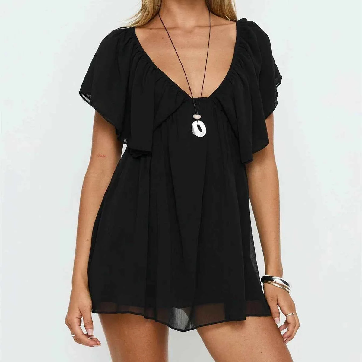 Black summer casual mini dress for women with ruffle details, from Corporación Turística, perfect for warm weather.