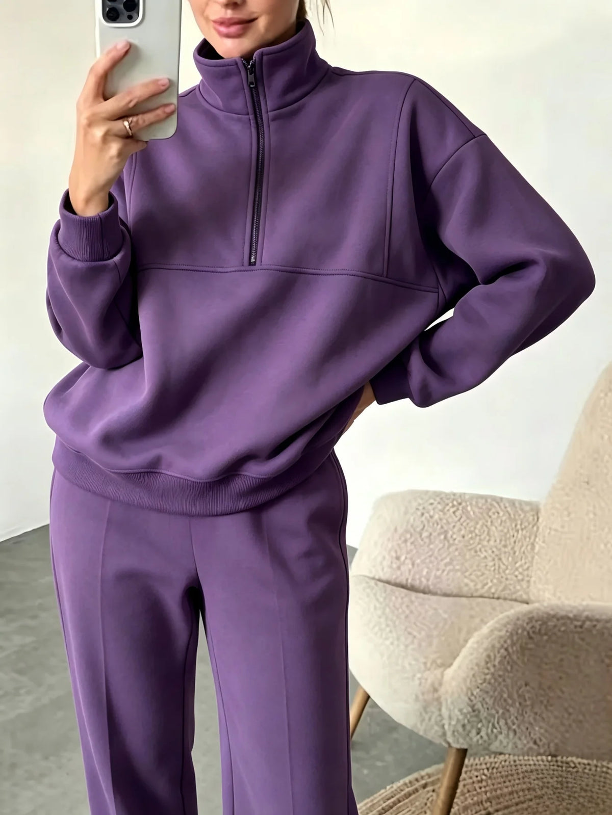 Black sweatshirt and pants set by Corporación Turística, featuring a half-zip sweatshirt and matching comfortable pants.