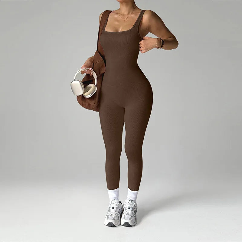 Black women's one-piece seamless sports jumpsuit by Corporación Turística, shown on a model in a workout pose.