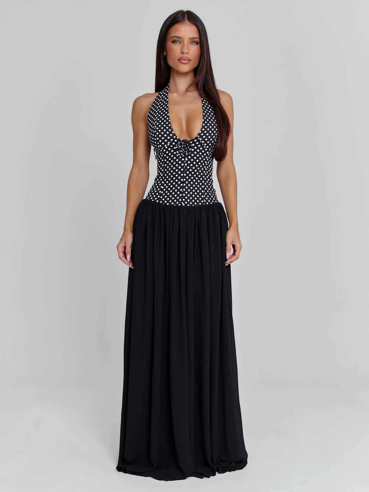 Elegant black sleeveless evening dress with halter neckline, featuring a sophisticated and stylish design by Corporación Turística.
