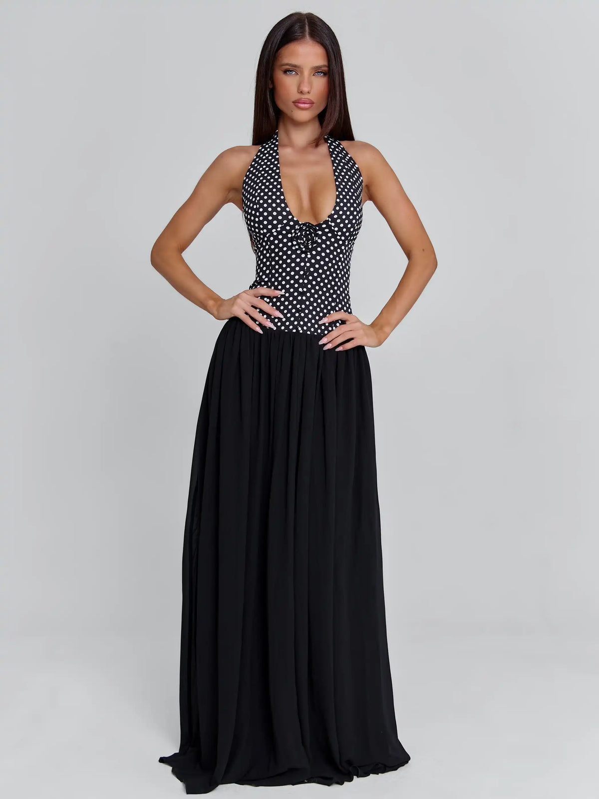 Elegant sleeveless black evening dress with halter neckline by Corporación Turística, perfect for formal occasions.
