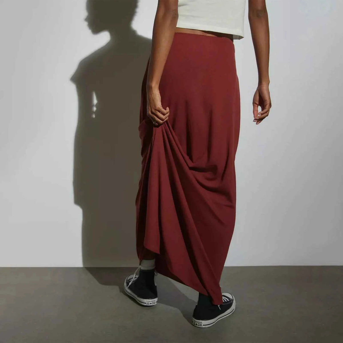 Long casual black skirts for women, straight fit, from Corporación Turística, shown in a relaxed style image.