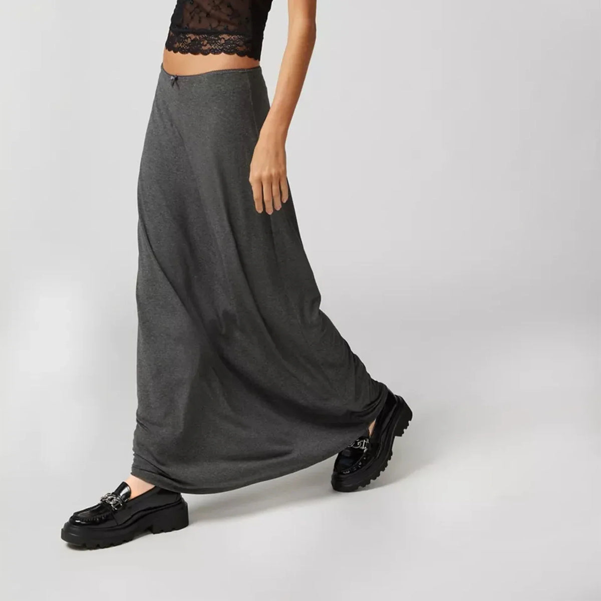 Long casual black skirts for women, straight style, from Corporación Turística, shown in a natural outdoor setting.