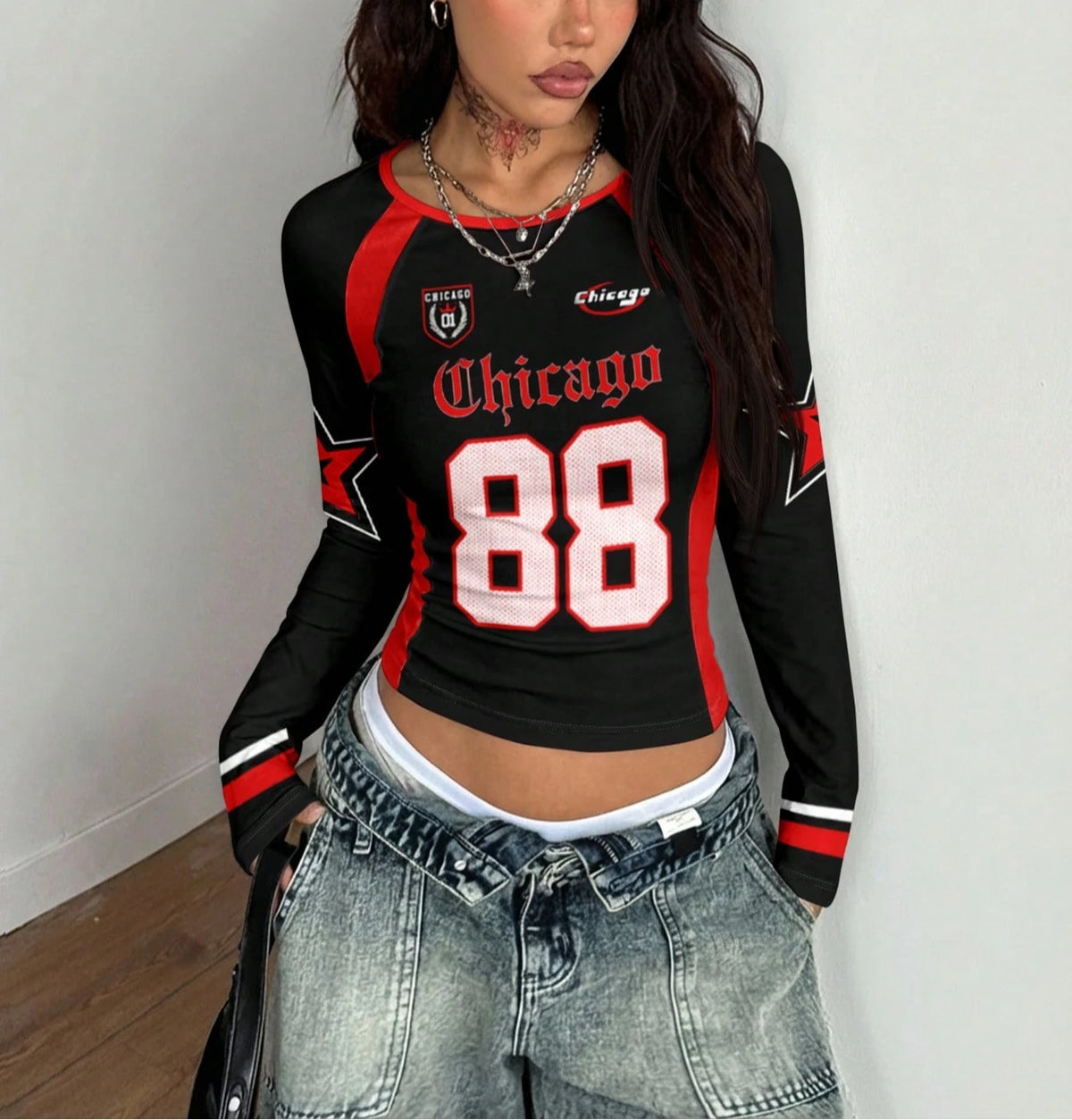 Long-sleeve crewneck T-shirt with color block design by Corporación Turística, shown in black and white.