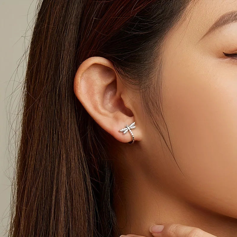 Silver S925 hoop earrings with delicate dragonfly and circonia details, showcasing intricate craftsmanship.
