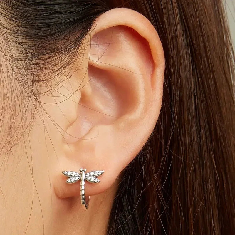 Silver S925 hoop earrings featuring delicate dragonfly and circular designs, perfect for casual or elegant wear.