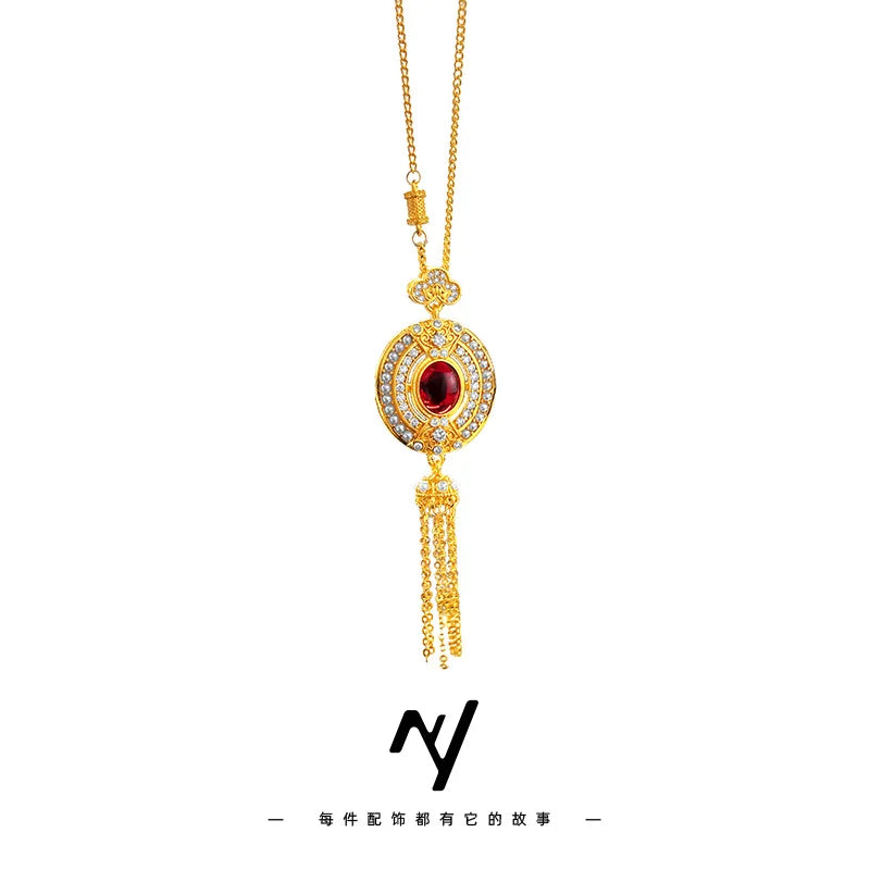 Elegant women's collar de clavícula by Corporación Turística featuring an oval ruby tassel pendant, gold-tone design.
