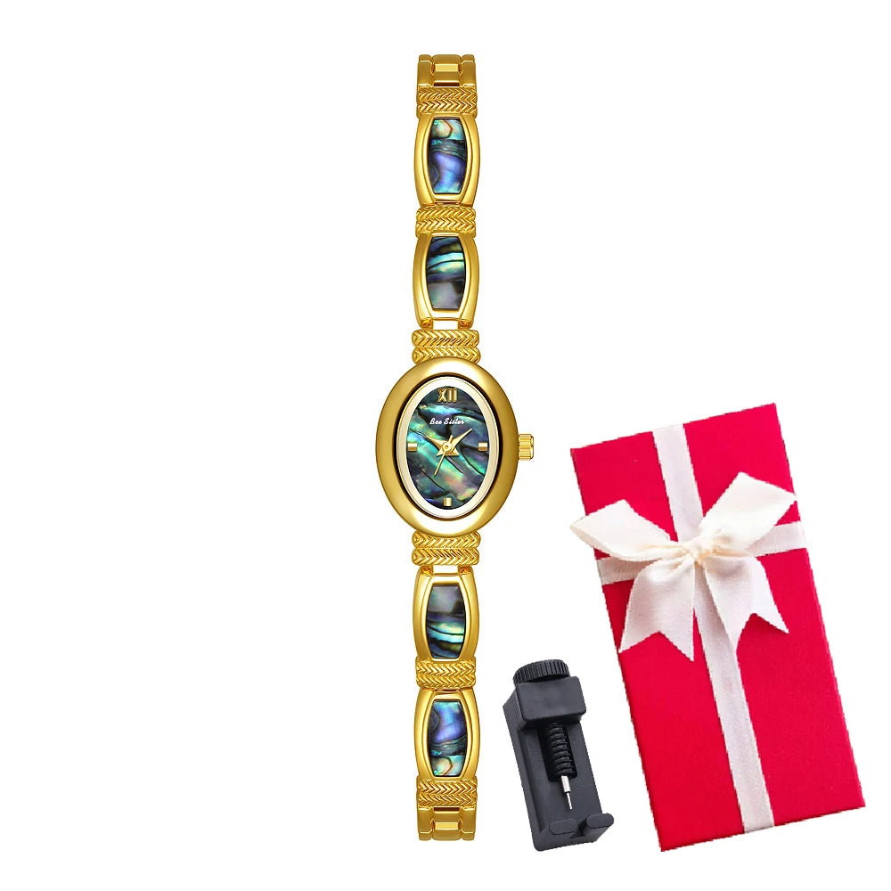 Elegant women's oval dial wristwatch by Corporación Turística with gold-tone finish and matching jewelry box.