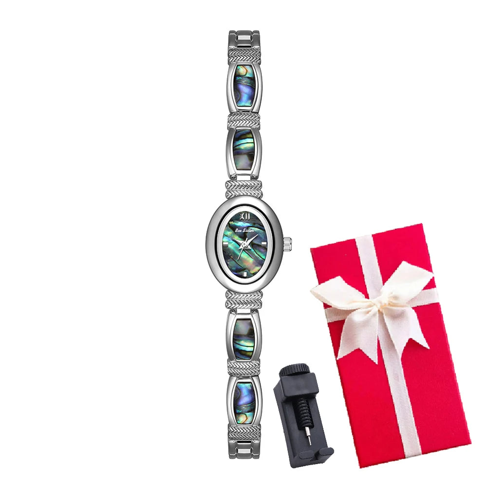 Gold oval-faced women's wristwatch by Corporación Turística with a sleek strap and elegant design.