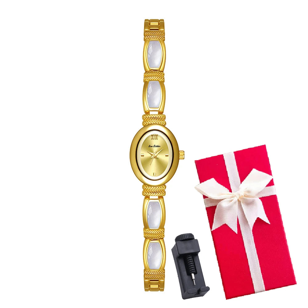 Gold women's bracelet watch with oval dial from Corporación Turística, featuring a sleek and elegant design with a matching box.