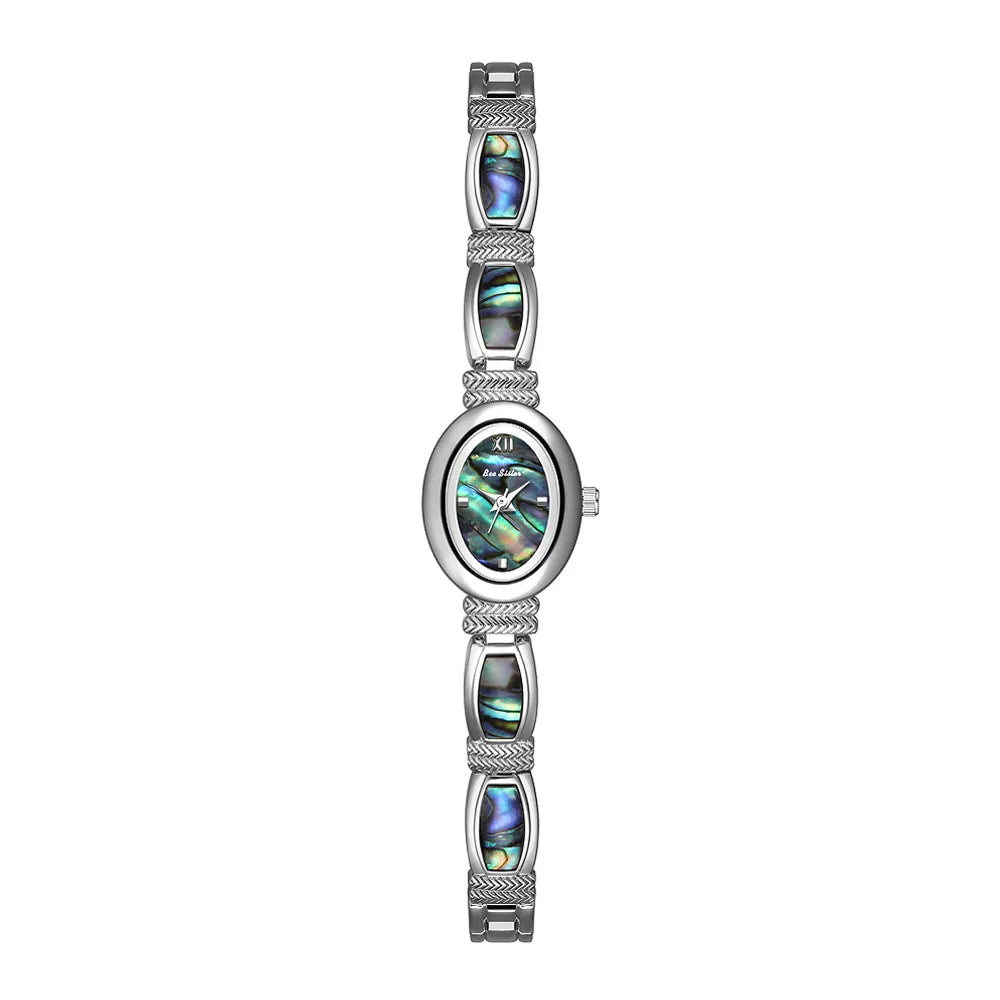 Gold oval-faced women's bracelet watch by Corporación Turística with elegant design and matching jewelry box.