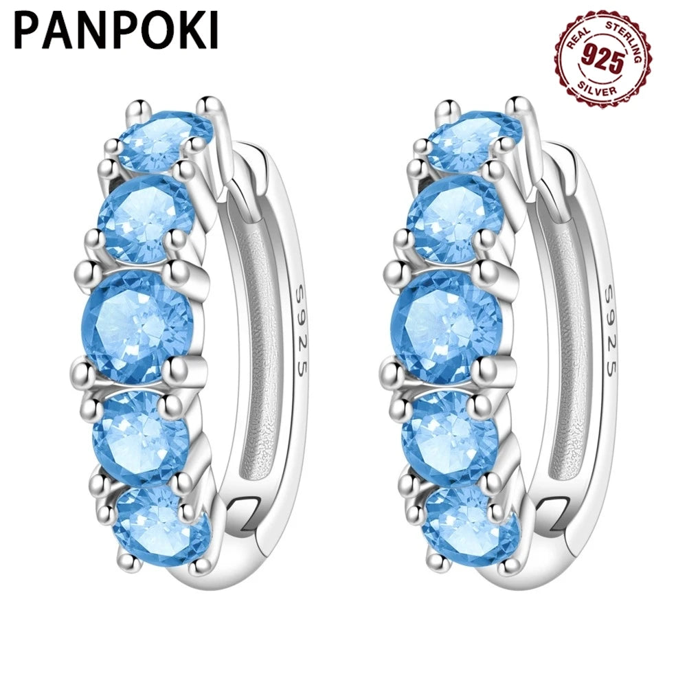 Colorful zirconia earrings with simplified design, featuring vibrant stones set in silver for a modern, stylish look.