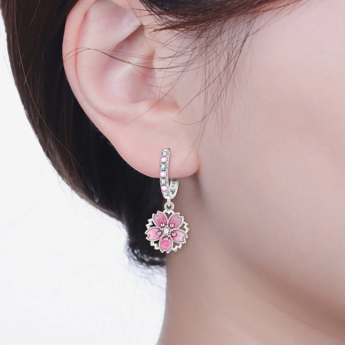 Sterling silver earrings with unique F-shaped design, crafted by Corporación Turística, featuring intricate detailing and polished finish.