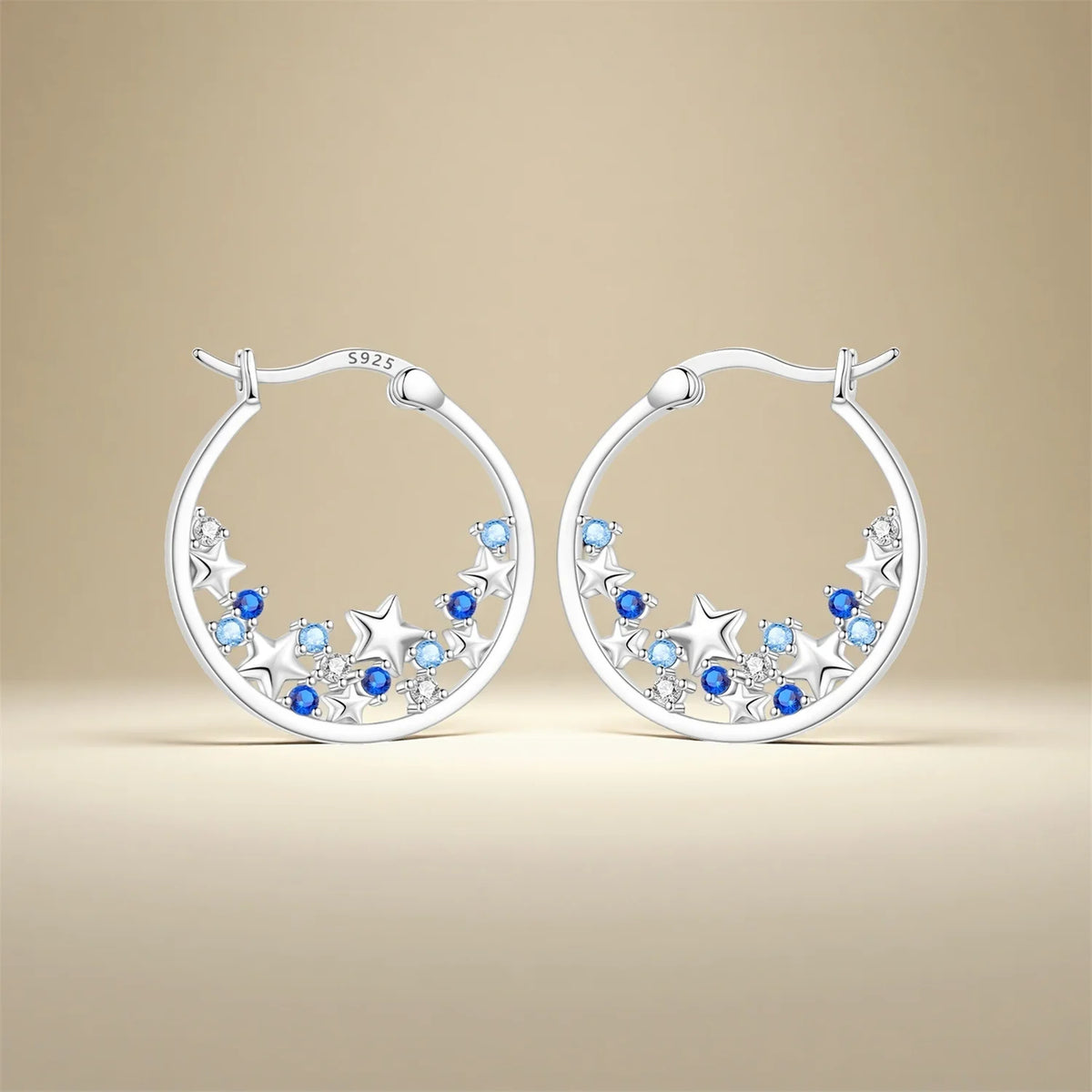 Sterling silver Orstarry earrings with blue cubic zirconia, crafted by Corporación Turística, featuring sparkling gemstone accents.
