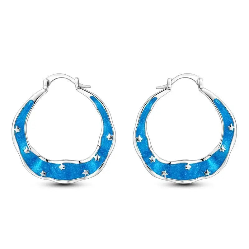 Sterling silver Orstarry earrings with sparkling blue zirconia, featuring a delicate, elegant design.