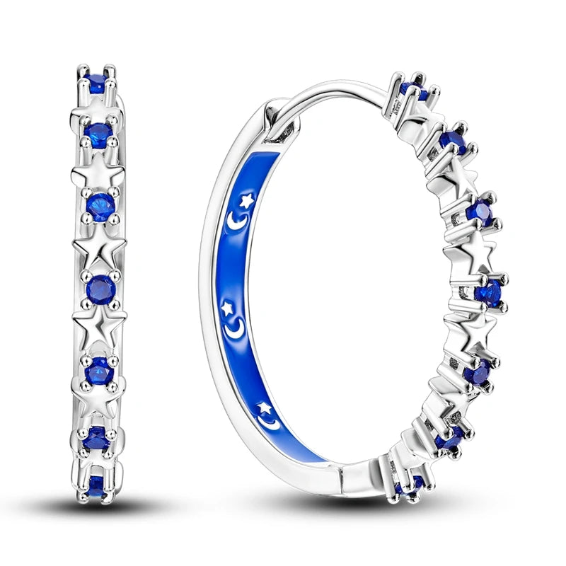 Sterling silver Orstarry earrings with blue cubic zirconia from Corporación Turística, showcasing elegant jewelry with sparkling stones.