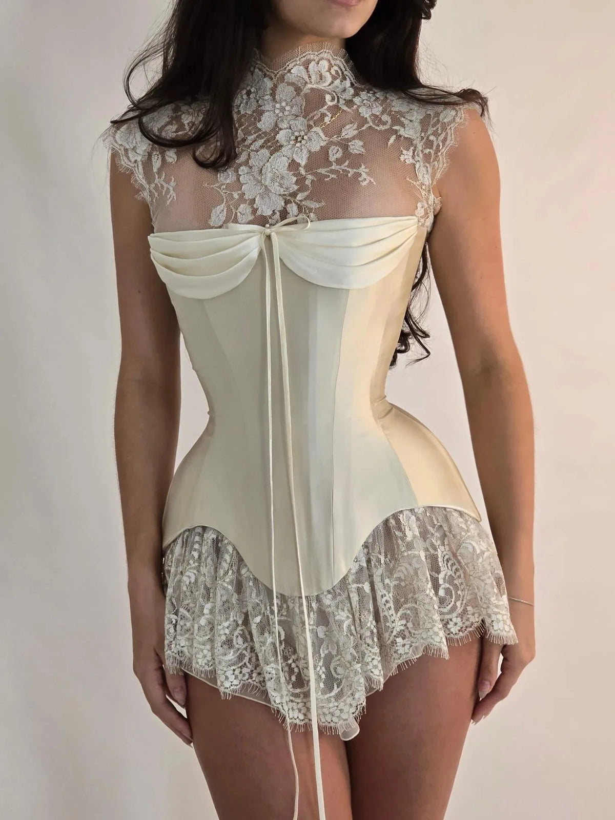 Elegant ivory evening dress by Corporación Turística featuring a personalized design with a high neckline and intricate details.