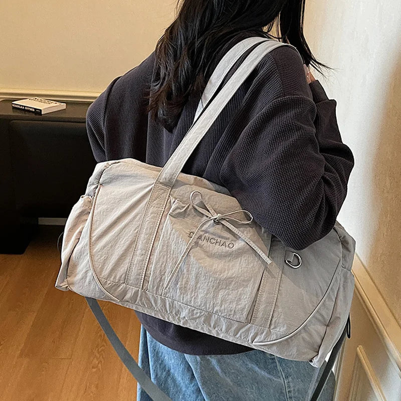 Large gym bag by Corporación Turística for yoga, travel, and hiking, shown in pink with spacious interior and sturdy handles.
