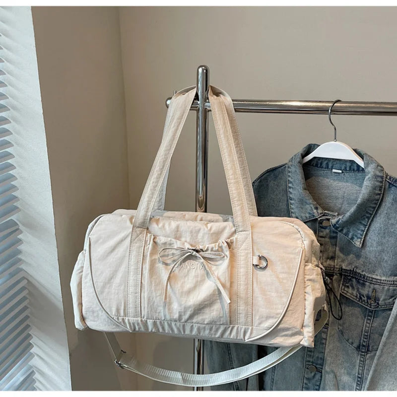 Large gym bag from Corporación Turística in pink, suitable for yoga, travel, and hiking with spacious compartments.