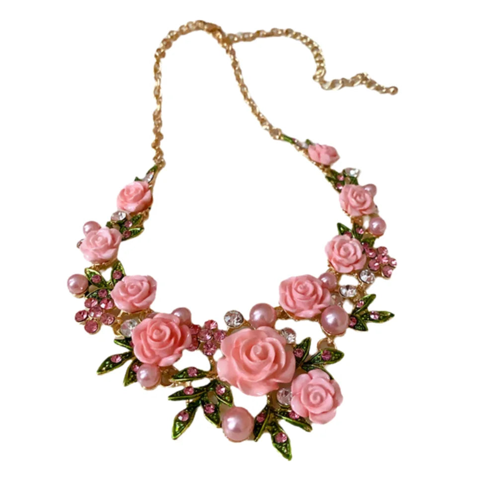 Elegant pink floral necklace with imitation diamonds by Corporación Turística, featuring intricate flower design and sparkling accents.