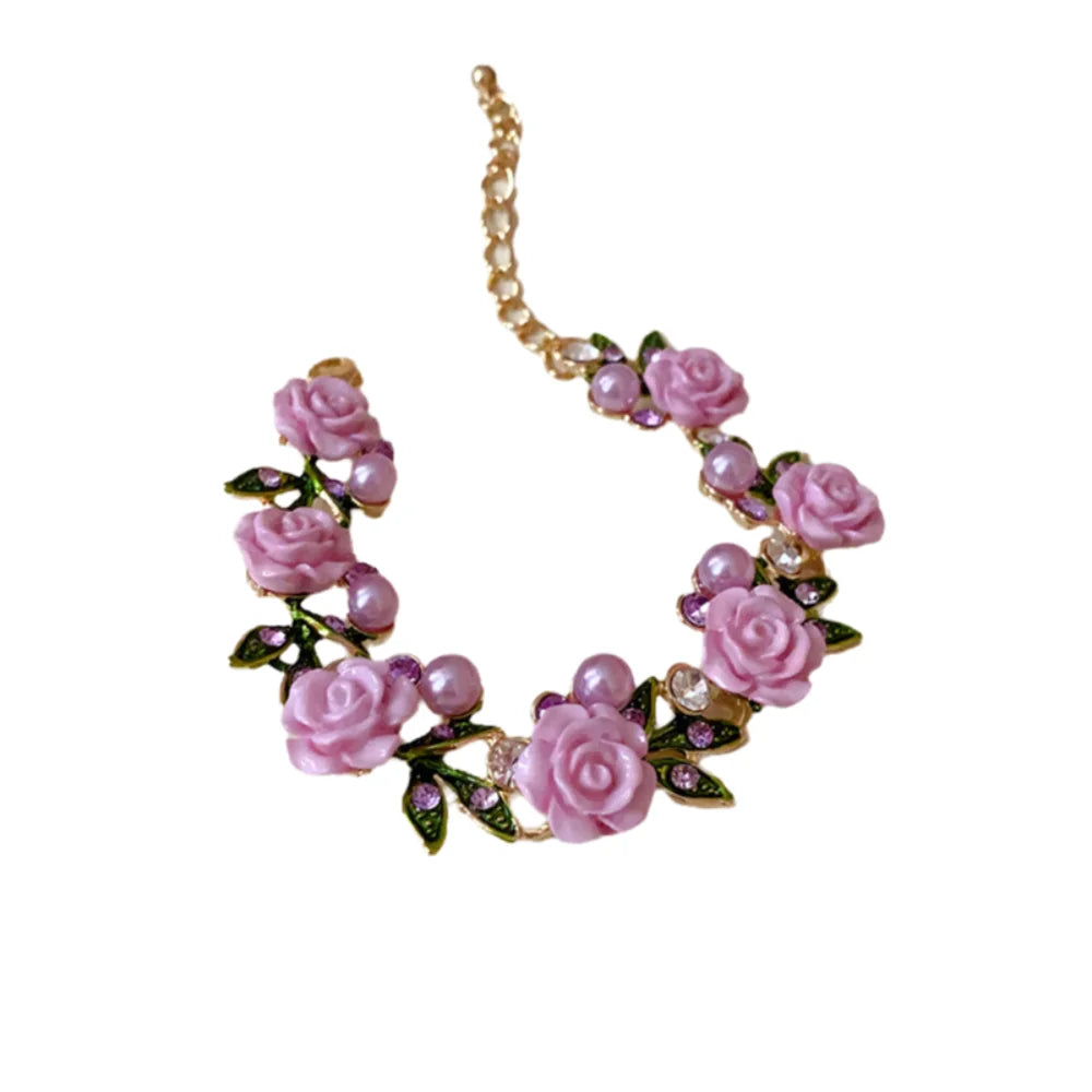 Luxurious pink floral collar with imitation diamonds, elegant jewelry piece by Corporación Turística, featuring roses and sparkling accents.