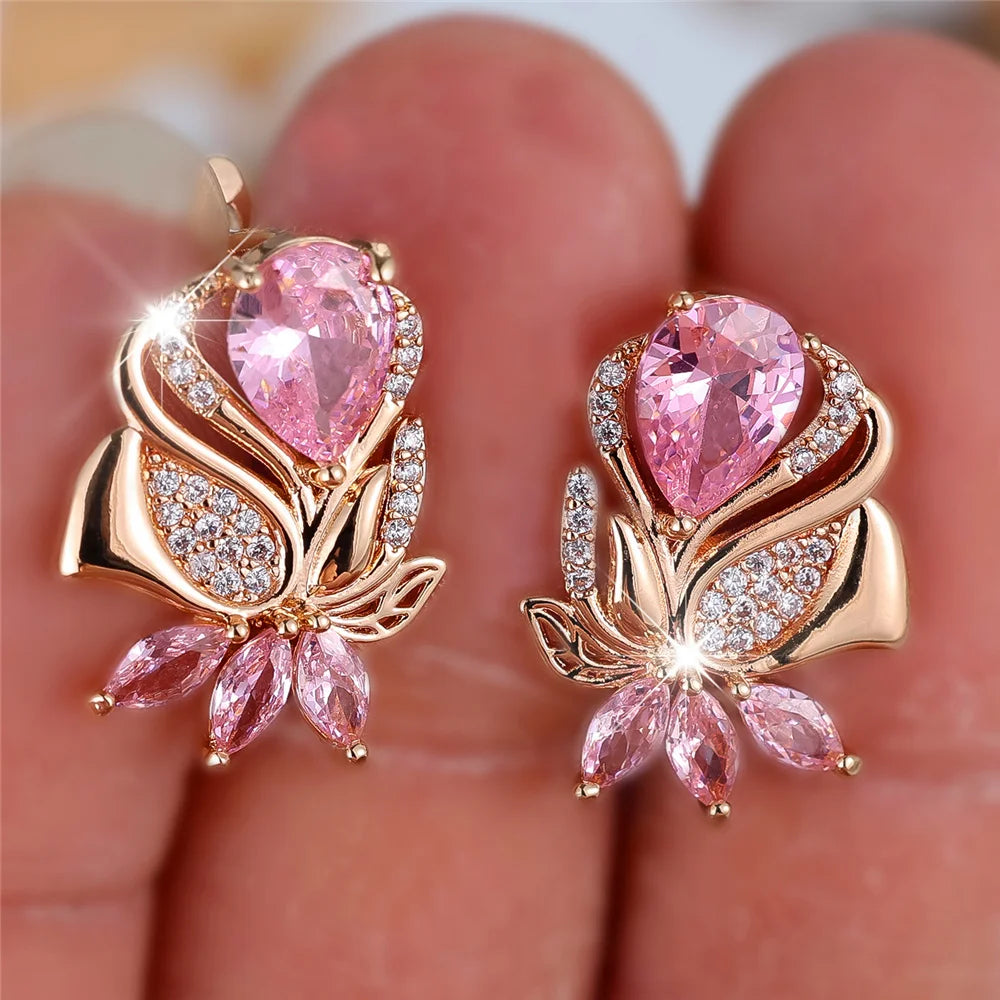 Luxury pink zircon hoop earrings by Corporación Turística, featuring sparkling pink stone details and elegant hoop design.