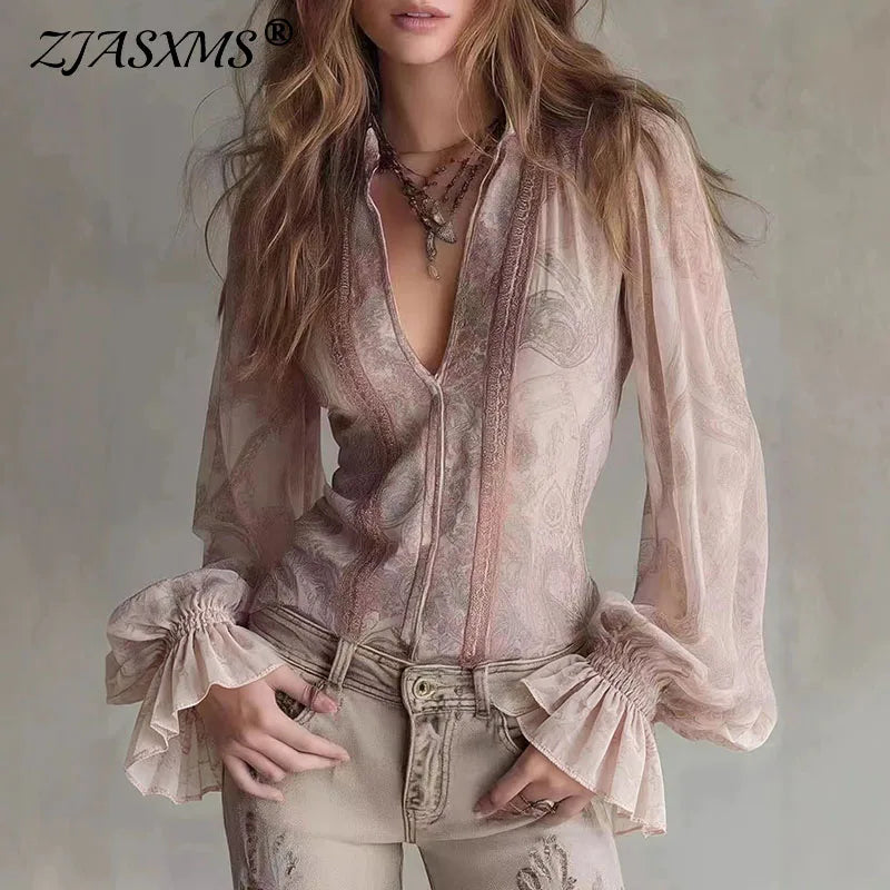 Pink transparent blouse with retro print for women, featuring long sleeves and fashionable design by Corporación Turística.