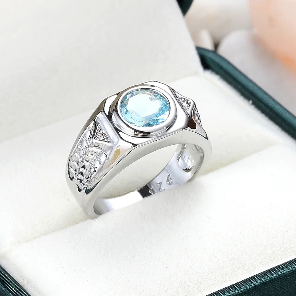 Blue cubic zirconia rings with aquamarine gemstones, crafted by Corporación Turística, displayed in a close-up shot.