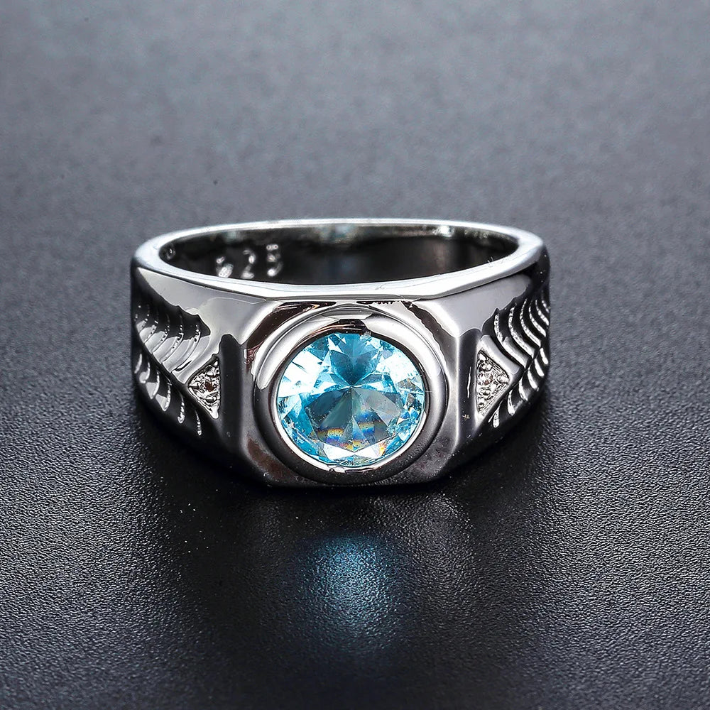 Blue cubic zirconia and aquamarine gemstone silver rings from Corporación Turística, showcasing intricate design and sparkling stones.